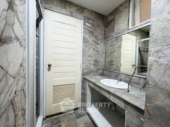 Elegant marble bathroom with large mirror and modern sink
