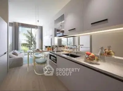 Modern kitchen with sleek cabinetry and open layout leading to a bright living area with garden view.