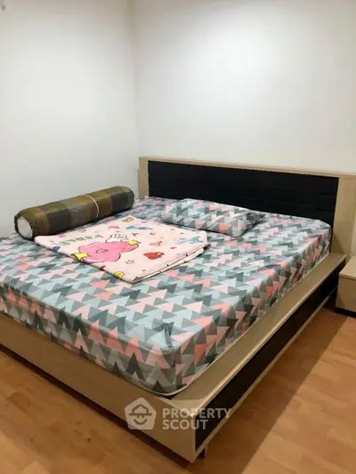 Cozy bedroom with modern bed and geometric patterned bedding