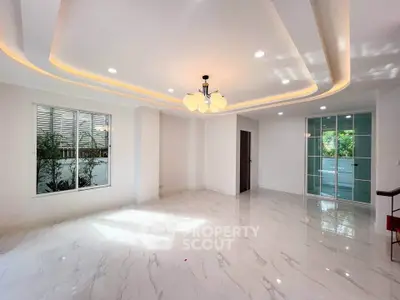 Spacious modern living room with elegant lighting and marble flooring