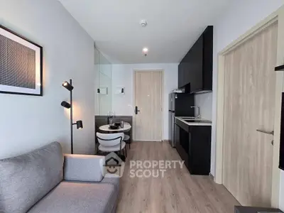 Modern apartment interior with sleek kitchen and cozy living area, perfect for urban living.