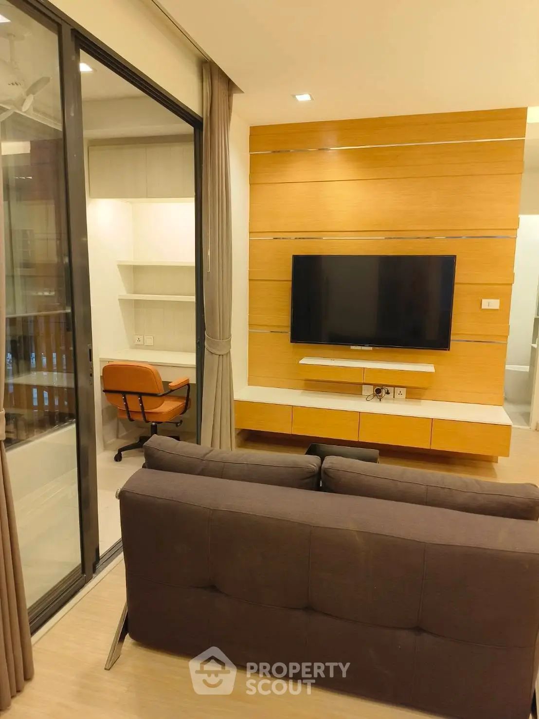 Modern living room with wall-mounted TV and cozy seating area