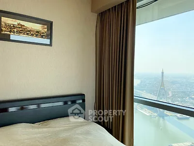 Luxurious bedroom with stunning city and river view from high-rise window