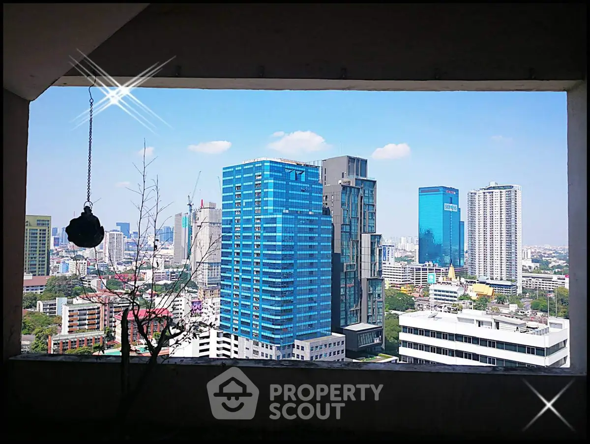 Stunning cityscape view from a high-rise building window, showcasing vibrant urban skyline.
