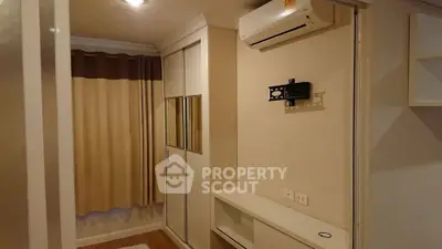 Modern bedroom with built-in wardrobe and air conditioning unit
