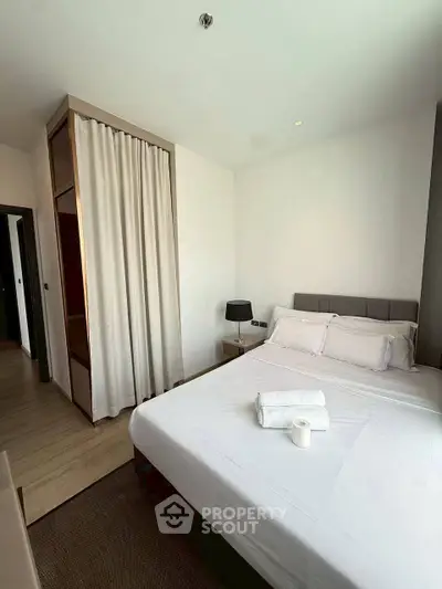 Modern bedroom with cozy bed and stylish decor in a contemporary apartment.