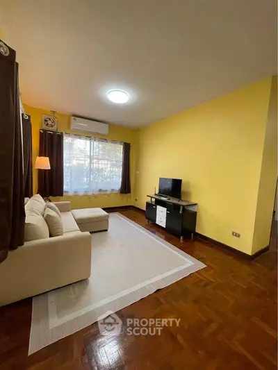 Spacious living room with cozy sofa and modern TV setup