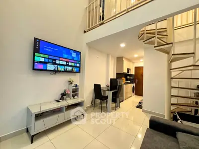 Modern loft apartment with spiral staircase and open-plan living area featuring a wall-mounted TV and sleek kitchen.