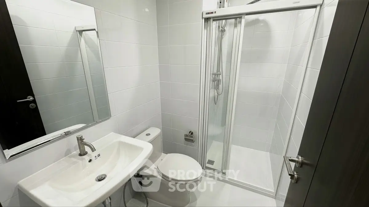 Modern bathroom with sleek shower and white fixtures