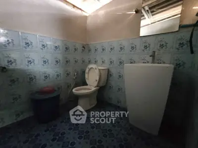 Cozy bathroom with vintage blue tile design and modern fixtures.