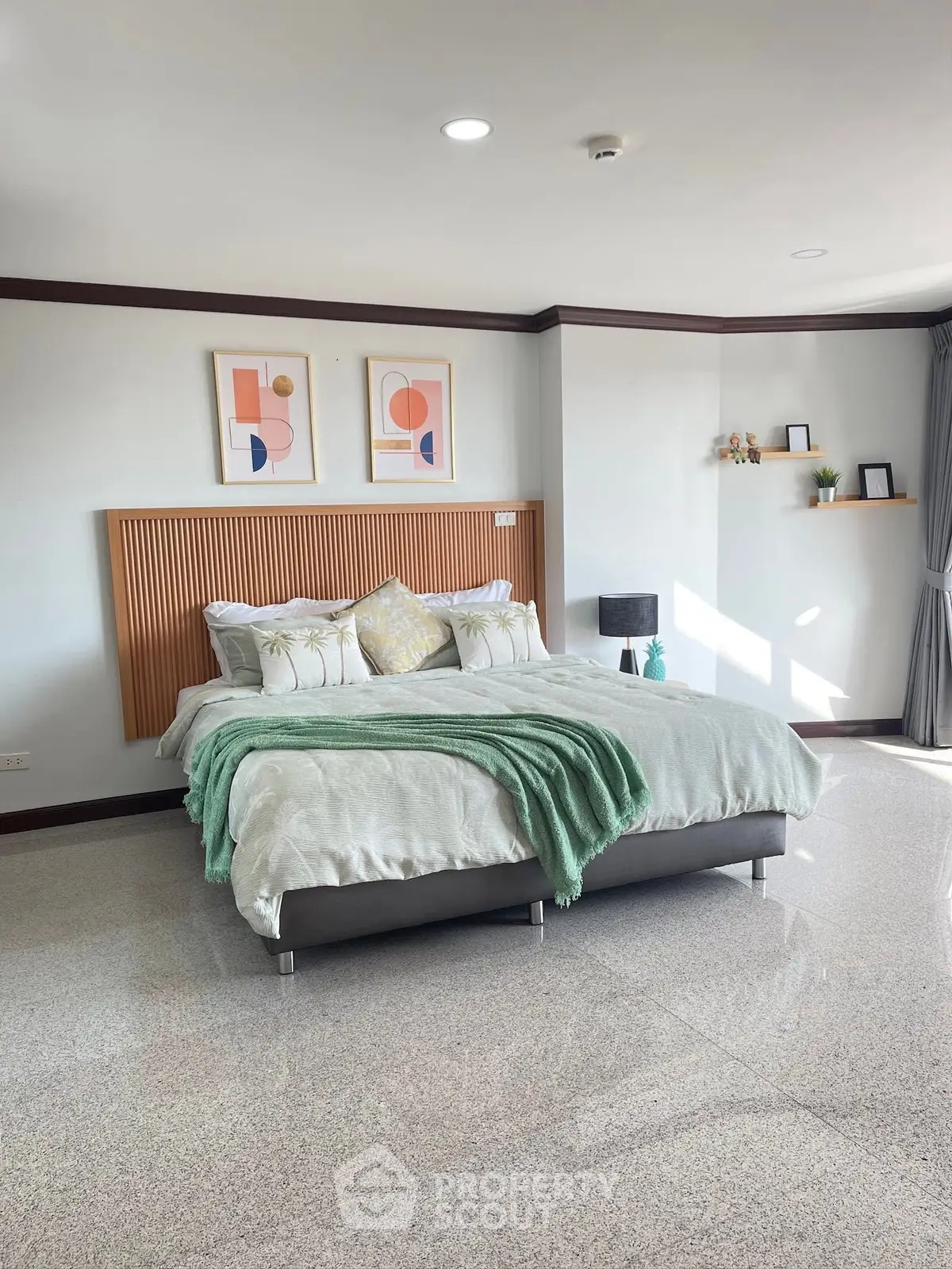 Spacious bedroom with modern decor and natural light