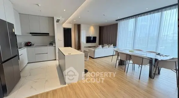 Modern open-plan kitchen and living room with sleek design and ample natural light.