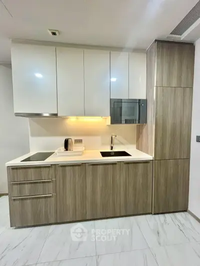 Modern kitchen with sleek cabinetry and built-in appliances in a stylish apartment.