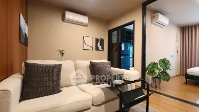 Modern living room with cozy sofa and stylish decor in open layout apartment.