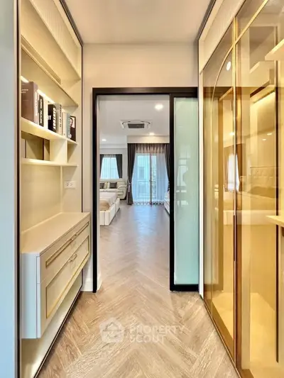 Luxurious modern hallway leading to a spacious living room with elegant decor and natural light.