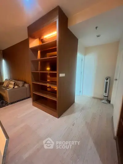 Modern living room with built-in wooden shelving and cozy seating area