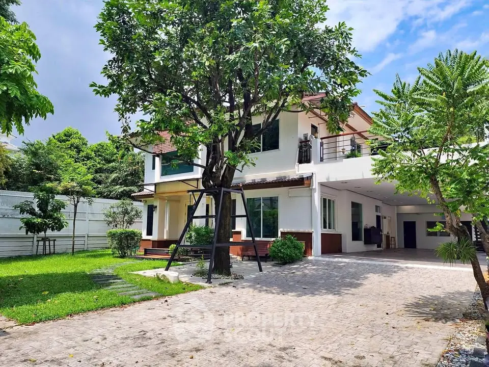 Charming two-story house with lush garden and spacious driveway
