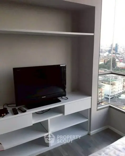 Modern living room with built-in TV unit and city view window