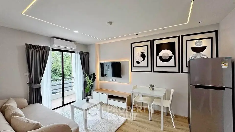 Modern living room with stylish decor, large window, and sleek furniture in a contemporary apartment.