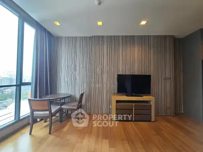 Modern living room with wooden flooring, stylish wall paneling, and large windows offering city views.