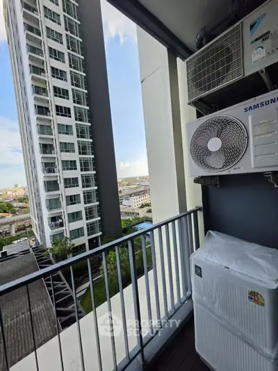 Modern high-rise balcony with air conditioning units and city view