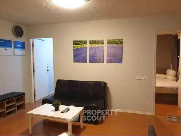 Cozy living room with modern decor and comfortable seating in a stylish apartment.