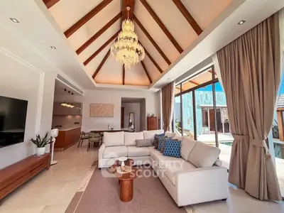 Luxurious living room with vaulted ceiling and elegant chandelier in a modern villa, featuring spacious open layout.
