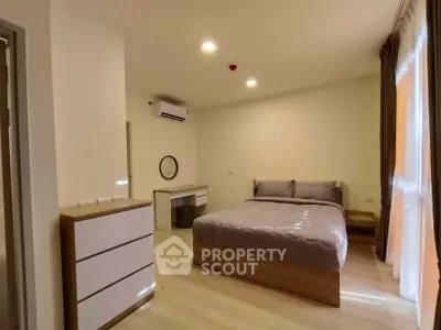 Spacious bedroom with modern furnishings and natural light