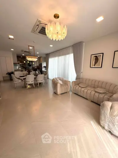 Spacious modern living room with elegant furniture and large windows