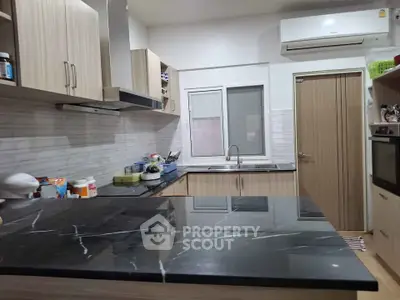 Modern kitchen with sleek countertops and built-in appliances