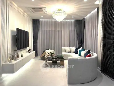 Luxurious modern living room with elegant chandelier and stylish decor