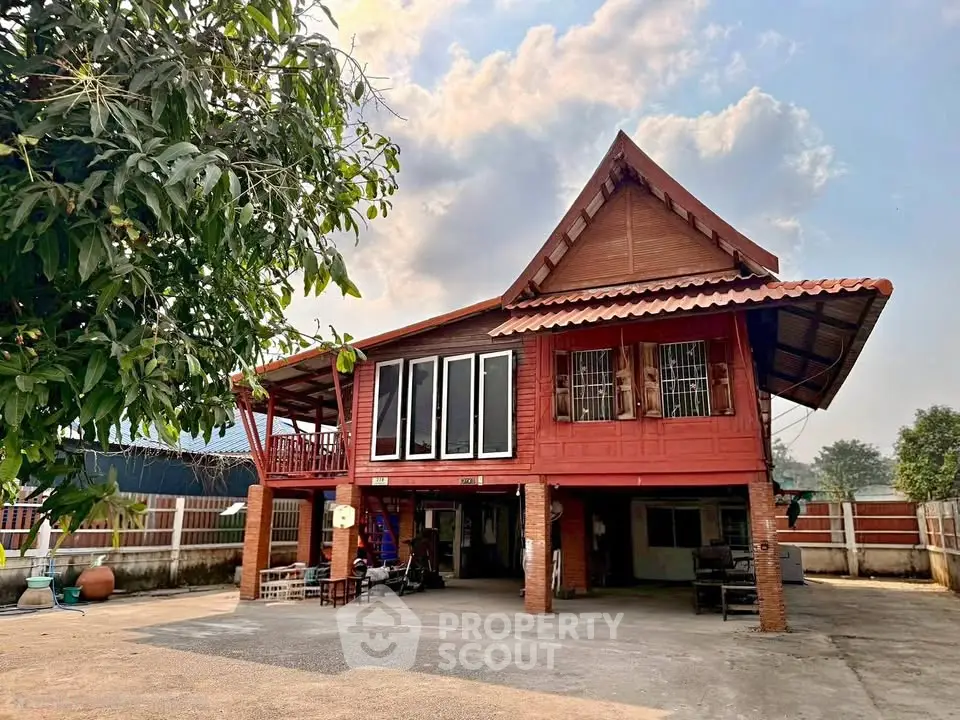 Charming traditional wooden house with elevated design and spacious outdoor area.