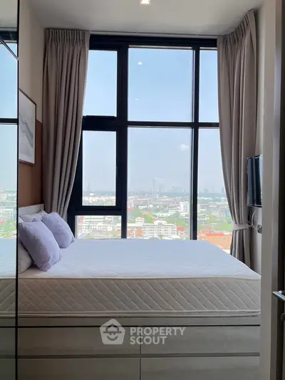 Modern bedroom with large windows offering stunning city views, featuring a cozy bed and elegant decor.