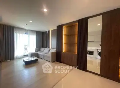 Spacious modern living room with elegant wooden accents and ample natural light.