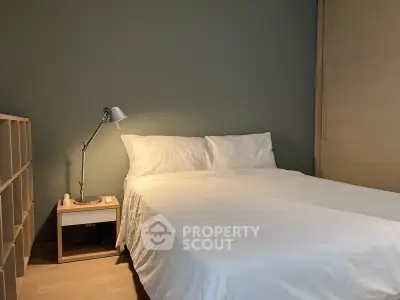 Cozy bedroom with minimalist design and soft lighting, perfect for relaxation.