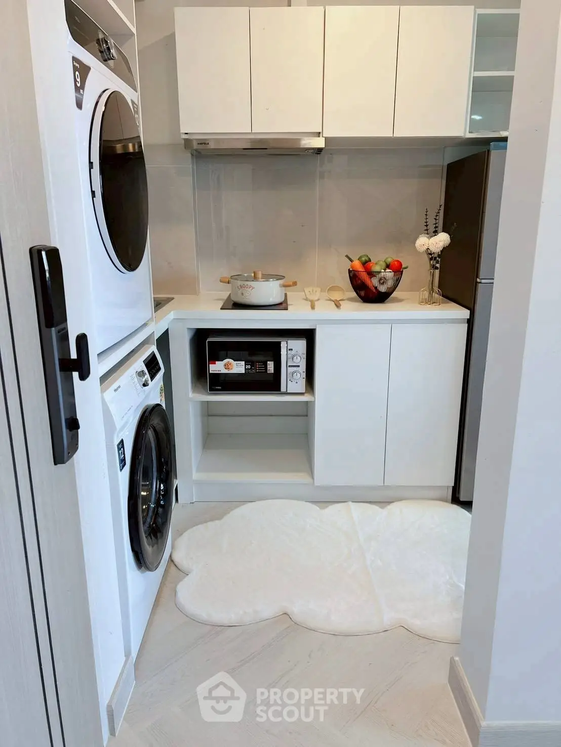 Modern compact kitchen with sleek appliances and stylish decor, perfect for urban living.