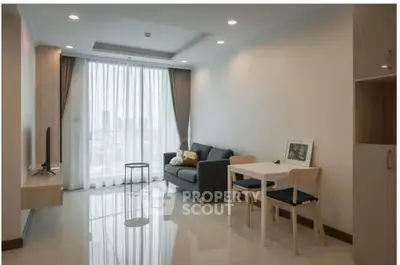 Modern living room with sleek furniture and large window in a stylish apartment.