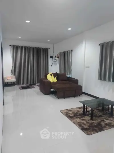 Spacious living room with modern decor and cozy seating area.