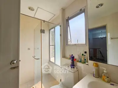 Bright bathroom with glass shower and modern fixtures