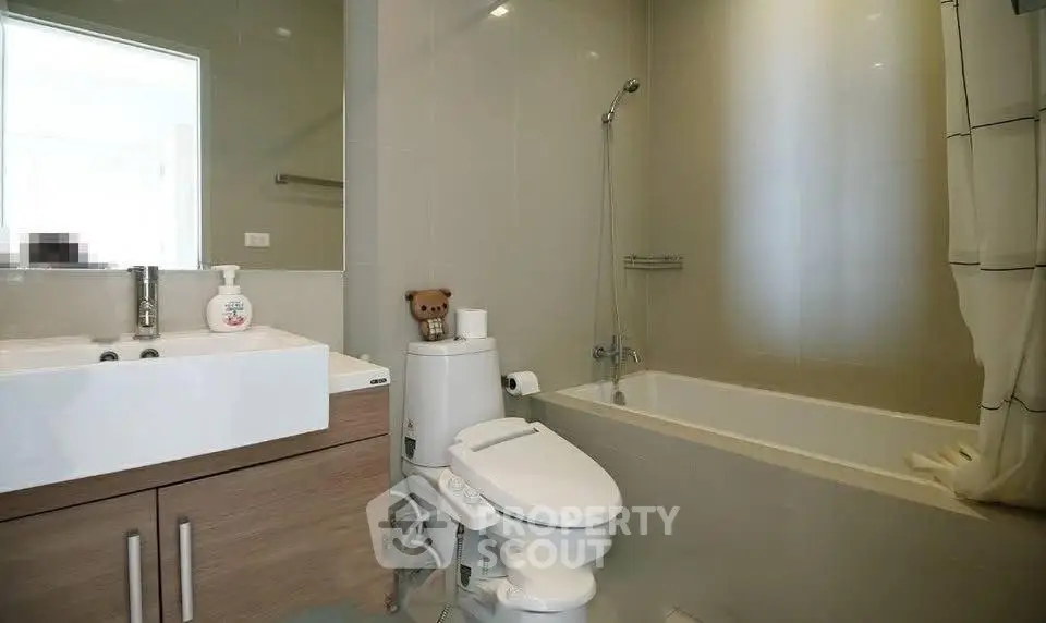 Modern bathroom with sleek fixtures and bathtub in contemporary apartment.