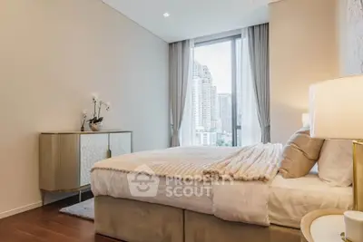 Luxurious bedroom with city view, elegant decor, and natural light