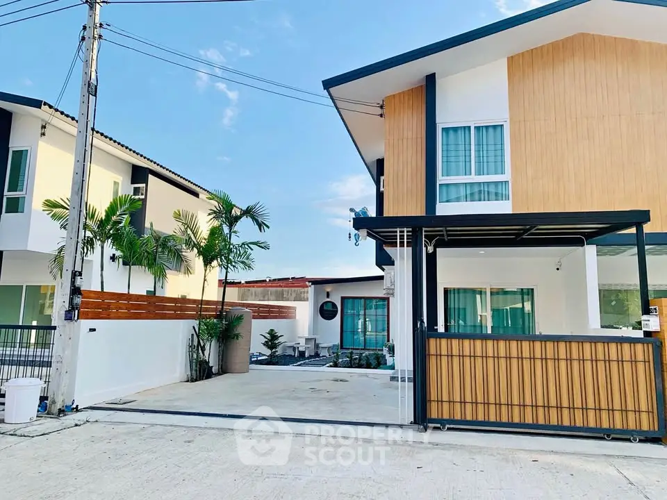 Modern two-story house with spacious driveway and contemporary design.