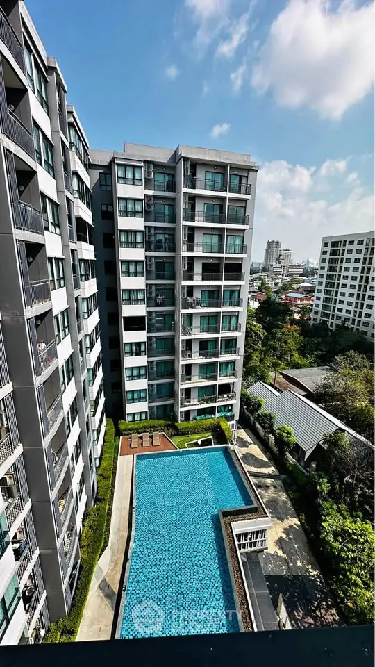 Modern condominium with swimming pool and city view, perfect for urban living.