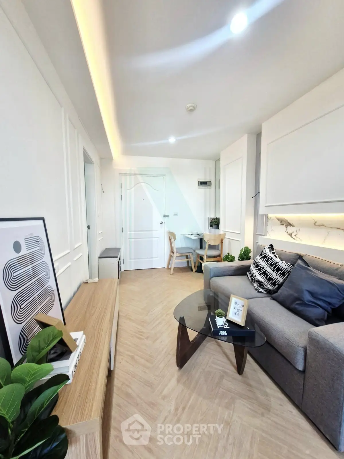 Modern living room with stylish decor and cozy seating area in a contemporary apartment.