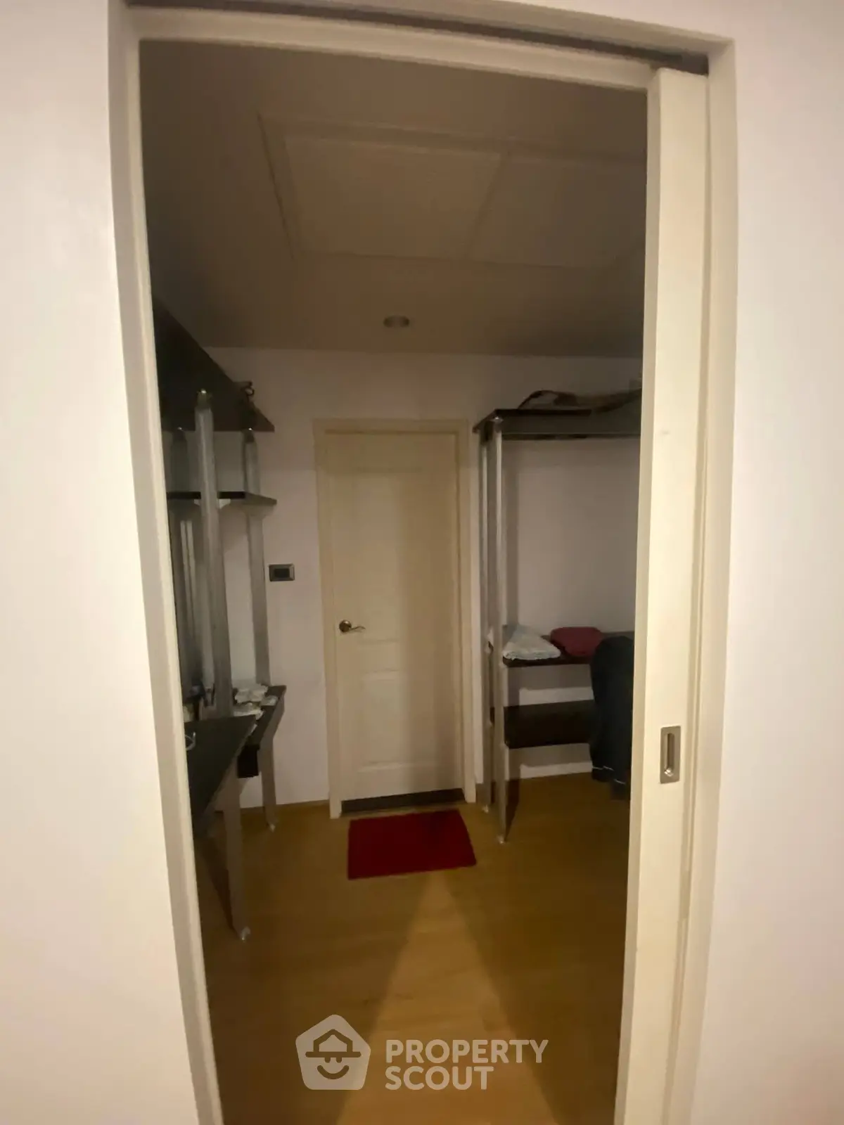 Cozy interior view of a small room with bunk bed and desk, ideal for compact living spaces.