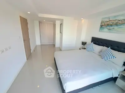 Spacious modern bedroom with elegant decor and ample natural light