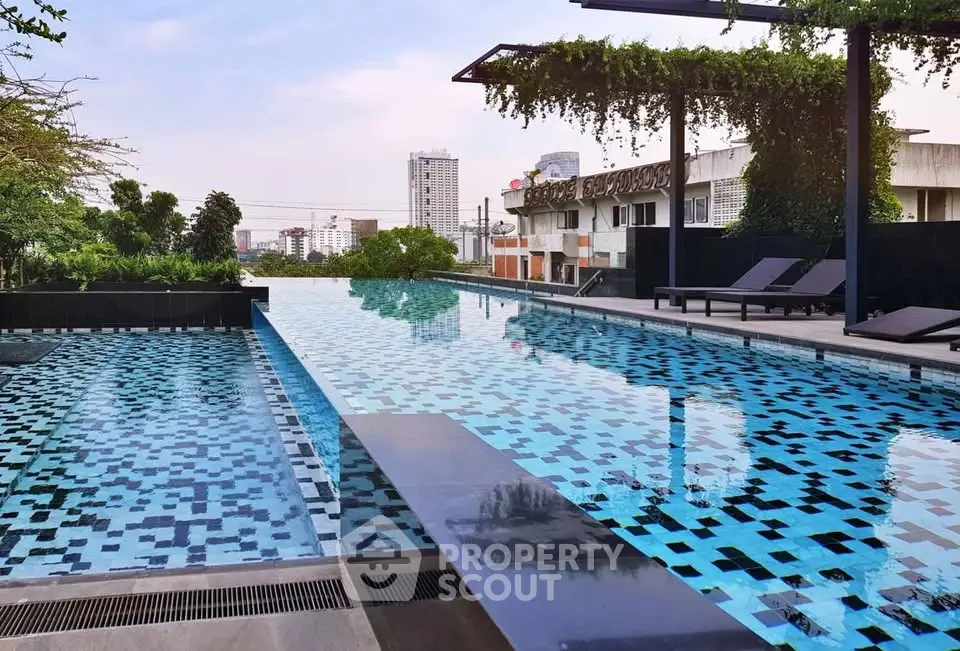 Luxurious rooftop infinity pool with city skyline views and modern lounge area.