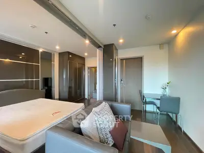 Modern studio apartment with stylish furniture and open layout in a high-rise building.