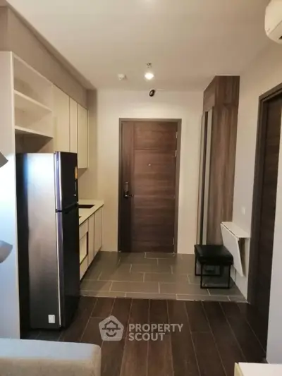 Modern apartment entrance with sleek kitchen and stylish decor
