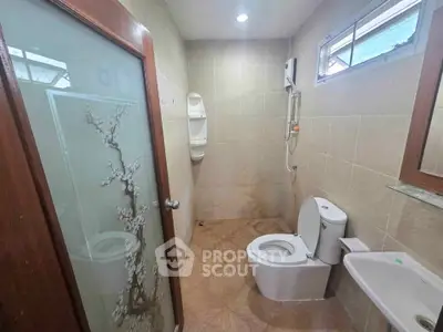 Modern bathroom with elegant glass door and sleek fixtures